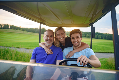 family in their golf cart
