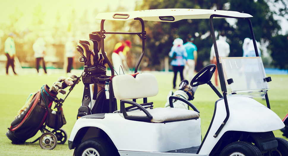 golf cart among blurred golfers