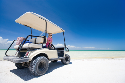 golf cart on tropical white sand beach